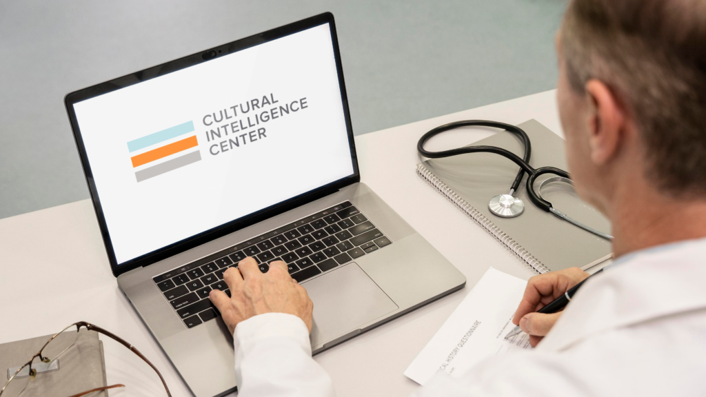 Doctor working on a laptop with the CQC logo on the screen